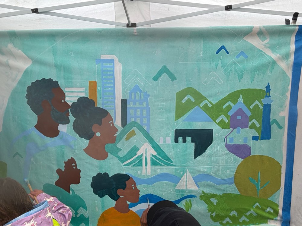 The mural in progress: four painted figures looking out over the Baltimore skyline and harbour